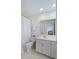 Bright bathroom with white vanity, toilet, and shower with white curtain at 1651 Atlantic Ave, Sullivans Island, SC 29482