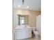 Bathroom with white vanity, mirror, toilet, and shower with white curtain at 1651 Atlantic Ave, Sullivans Island, SC 29482