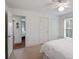 Bright bedroom with white walls and carpet and views into another room at 1651 Atlantic Ave, Sullivans Island, SC 29482