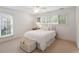 Cozy bedroom with a bed, neutral colors, and natural light from the windows at 1651 Atlantic Ave, Sullivans Island, SC 29482
