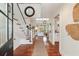 Bright foyer with hardwood floors, staircase, and an open view to the living room at 1651 Atlantic Ave, Sullivans Island, SC 29482