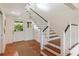 Entryway with wood floors, staircase, and natural light from the exterior door at 1651 Atlantic Ave, Sullivans Island, SC 29482
