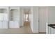 Hallway with white doors, carpet, and built-in shelves at 1651 Atlantic Ave, Sullivans Island, SC 29482