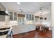 Bright kitchen with white cabinets, wood floors, and a cozy breakfast nook with a table at 1651 Atlantic Ave, Sullivans Island, SC 29482