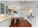 Bright kitchen featuring built-in banquette seating, wood floors, and modern appliances at 1651 Atlantic Ave, Sullivans Island, SC 29482