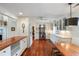 Spacious kitchen with wooden floors, white cabinets, stainless steel appliances, and a center island at 1651 Atlantic Ave, Sullivans Island, SC 29482