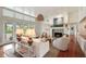 Bright and spacious living room featuring a fireplace, hardwood floors, and access to the deck at 1651 Atlantic Ave, Sullivans Island, SC 29482