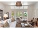 Bright living room with large windows, comfortable seating, and views of the outdoor area at 1651 Atlantic Ave, Sullivans Island, SC 29482