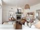 Comfortable living room with a stone fireplace, white furnishings, and hardwood floors at 1651 Atlantic Ave, Sullivans Island, SC 29482