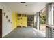 Enclosed patio featuring yellow decor, concrete floors, and natural light, perfect for outdoor living and entertaining at 1651 Atlantic Ave, Sullivans Island, SC 29482