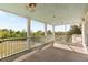 Spacious porch with ceiling fan and railing offers serene views of the property at 1651 Atlantic Ave, Sullivans Island, SC 29482