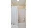 Shower with white shower curtain, tile surround, and shower head at 1651 Atlantic Ave, Sullivans Island, SC 29482