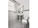 Charming bathroom featuring classic black and white tile and pedestal sink at 17 8Th Ave # 17G, Charleston, SC 29403