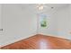 Sun-filled bedroom boasting hardwood floors, ceiling fan and a large window at 17 8Th Ave # 17G, Charleston, SC 29403
