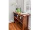 Charming dining area featuring a wooden table with decorative items, hardwood floors, and natural light at 17 8Th Ave # 17G, Charleston, SC 29403