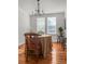 Cozy dining area with hardwood floors, natural light, comfortable seating, and stylish chandelier at 17 8Th Ave # 17G, Charleston, SC 29403