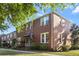 Brick townhouse featuring an American flag, mature landscaping, and ample curb appeal at 17 8Th Ave # 17G, Charleston, SC 29403