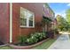 Charming brick townhouse with manicured landscaping and an American flag at 17 8Th Ave # 17G, Charleston, SC 29403