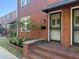 Charming brick townhouse entrance featuring a black screen door, classic mailbox and landscaped garden bed at 17 8Th Ave # 17G, Charleston, SC 29403
