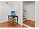 Hallway featuring stairs, wood floors, and a workspace with a small TV at 17 8Th Ave # 17G, Charleston, SC 29403