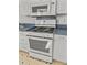 Modern gas oven, microwave, and blue countertops are featured in this kitchen at 17 8Th Ave # 17G, Charleston, SC 29403
