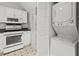 Functional kitchen featuring white appliances, gas range, ample storage, and washer/dryer combo at 17 8Th Ave # 17G, Charleston, SC 29403