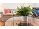 Close-up of a coffee table showing stylish decor in a comfortable living room with a sofa and natural light at 17 8Th Ave # 17G, Charleston, SC 29403
