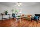 Bright living room featuring hardwood floors, comfortable seating, stylish decor, and abundant natural light at 17 8Th Ave # 17G, Charleston, SC 29403