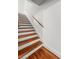 Staircase with wood treads and white risers, showcasing the home's modern design at 17 8Th Ave # 17G, Charleston, SC 29403