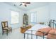 Light-filled bedroom featuring a bed, bookcase, and trunk, designed for relaxation and study at 1700 Paradise Lake Dr, Mount Pleasant, SC 29464