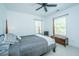 Charming bedroom features a four-poster bed, ceiling fan, window, and bench. The room offers a comfortable retreat at 1700 Paradise Lake Dr, Mount Pleasant, SC 29464