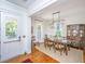 Elegant dining room with a modern chandelier, a glass-top table with seating for six, and hardwood floors at 1700 Paradise Lake Dr, Mount Pleasant, SC 29464