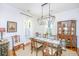 Refined dining area featuring a glass table, decorative china cabinet, and white wainscoting at 1700 Paradise Lake Dr, Mount Pleasant, SC 29464