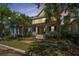 Charming yellow two-story home featuring a welcoming front porch and well-manicured lawn at 1700 Paradise Lake Dr, Mount Pleasant, SC 29464