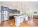 Bright kitchen with dark cabinetry, stainless appliances, white countertops and hardwood floors at 1700 Paradise Lake Dr, Mount Pleasant, SC 29464