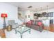 Bright living room with hardwood floors, seating, area rug, stairs and kitchen at 1700 Paradise Lake Dr, Mount Pleasant, SC 29464