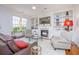 Bright living room features custom built-ins, a cozy fireplace, and comfortable seating for relaxing and entertaining at 1700 Paradise Lake Dr, Mount Pleasant, SC 29464