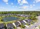An aerial view of a community with a pond, solar panels, and well-kept lawns at 187 Brittondale Rd, Summerville, SC 29485