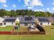 Aerial view of fenced backyards with solar panels, patio furniture, and a grill at 187 Brittondale Rd, Summerville, SC 29485