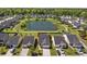 A community with a pond, sidewalks, landscaping, and well-maintained homes and driveways in a suburban setting at 187 Brittondale Rd, Summerville, SC 29485