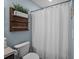 Bright bathroom with plants on shelves above the toilet, next to a shower with a curtain at 187 Brittondale Rd, Summerville, SC 29485
