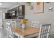 Dining room features a kitchen view, a stylish chandelier, modern art, and an inviting atmosphere at 187 Brittondale Rd, Summerville, SC 29485