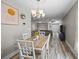 Bright dining room features a chandelier, modern art, and a dining table for four guests at 187 Brittondale Rd, Summerville, SC 29485