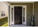Elegant black front door with sidelights, creating a welcoming and stylish entrance to the home at 187 Brittondale Rd, Summerville, SC 29485