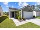 Inviting front entrance featuring a well-manicured lawn and tidy landscaping, enhancing curb appeal at 187 Brittondale Rd, Summerville, SC 29485