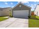 View of the home's exterior showcasing the garage, front lawn and manicured landscaping at 187 Brittondale Rd, Summerville, SC 29485