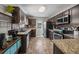 Modern kitchen features granite countertops, stainless steel appliances, and dark wooden cabinets at 187 Brittondale Rd, Summerville, SC 29485