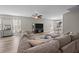 Open living room with wood flooring, large sectional couch, and view into the kitchen and dining area at 187 Brittondale Rd, Summerville, SC 29485