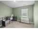 Home office setup with a desk, chair, and white drawers under a window with blinds at 187 Brittondale Rd, Summerville, SC 29485