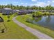 Scenic view of a serene pond with a walking path and lush green surroundings at 187 Brittondale Rd, Summerville, SC 29485